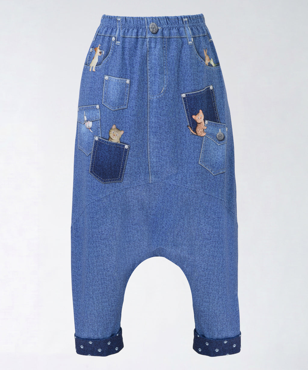 クニオコレクション(KUNIO COLLECTION)のポケポケサルエルパンツ(ネイビー)。バイカラーのデニムパッチワーク風デザインに、フェイクポケットやフェイクボタンをリアルに表現した楽しいだまし絵(トロンプルイユ)プリントのサルエルパンツ。裾の折り返しやヒップのポケットから可愛いキャラクターたちが顔を出す遊び心溢れるデザインで、さらりとした軽い着心地のストレッチ素材を使用したボトムス。